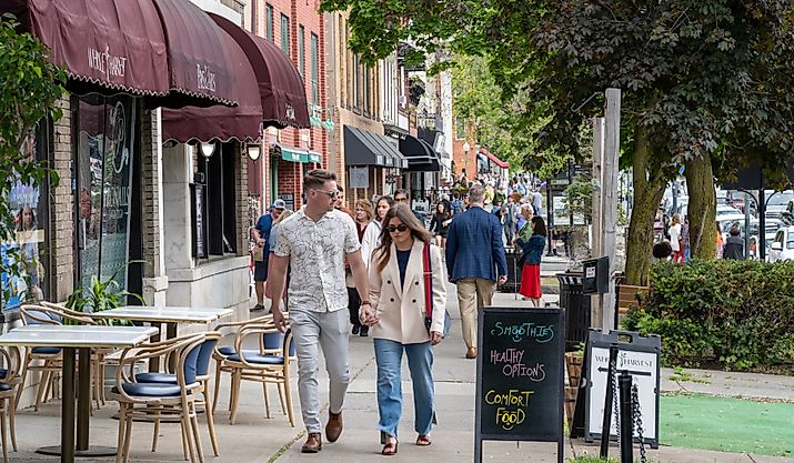 People walking on sidewalk in downtown Saratoga Springs, New York, via aimintang / iStock.com 