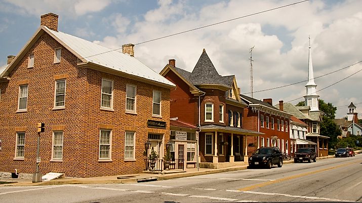 Street view of downtown Funkstown, Maryland, featuring historic brick buildings, small businesses, and tree-lined sidewalks. By Acroterion, CC BY-SA 3.0, https://commons.wikimedia.org/w/index.php?curid=7275466