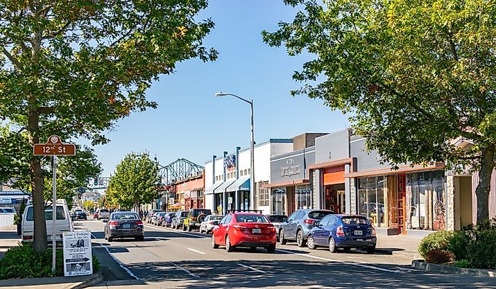Cars on the street in downtown Astoria with Astoria-Megler Bridge. Image credit Enrico Powell via Shutterstock