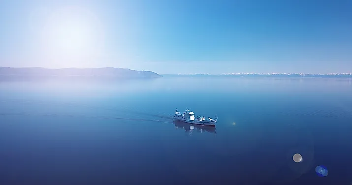 Aerial view of a ship floating in the water. Lake Baikal. Blue water.