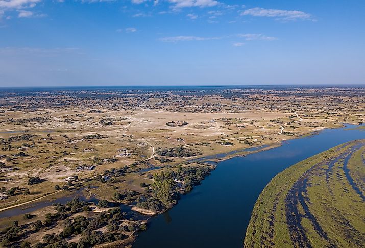 Aerial landscape in Okavango delta on Namibia and Angola border. River with shore and green vegetation after rainy season. Image credit Artush via Shutterstock. 