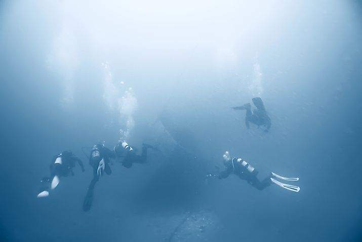 Divers searching for a shipwreck at sea.