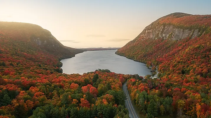 Fall foliage surrounding a beautiful lake.
