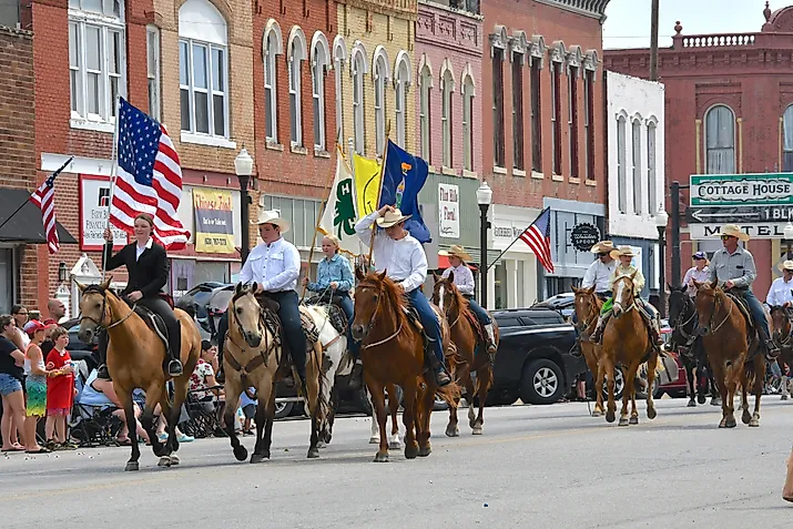 Horseback riders in a parade in Council Grove, Kansas. Image credit Mark Reinstein via Shutterstock
