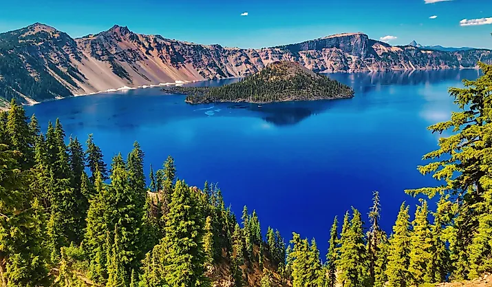 Wizard Island rises from the deep blue waters of Crater Lake in Crater Lake National Park, Oregon.