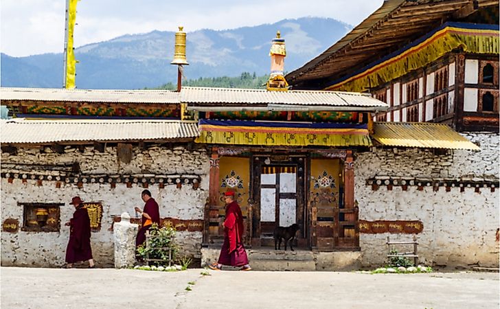 Monks circling Tamzhing Monastery in Bumthang district. Editorial credit: Elisha Donkin / Shutterstock.com.