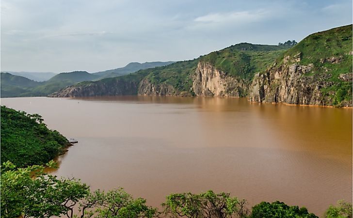The calm brown water of Lake Nyos, infamous for CO2 eruption with many deaths. The calm brown water of Lake Nyos, infamous for CO2 eruption with many deaths.