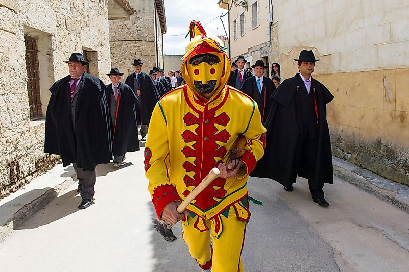 During the entire day, a man dressed as the Devil, the Coacho, runs through the village, holding a whip and attacks people by whipping them. Image credit: nationalgeographic.com/ During the entire day, a man dressed as the Devil, the Coacho, runs through the village, holding a whip and attacks people by whipping them. Image credit: nationalgeographic.com/