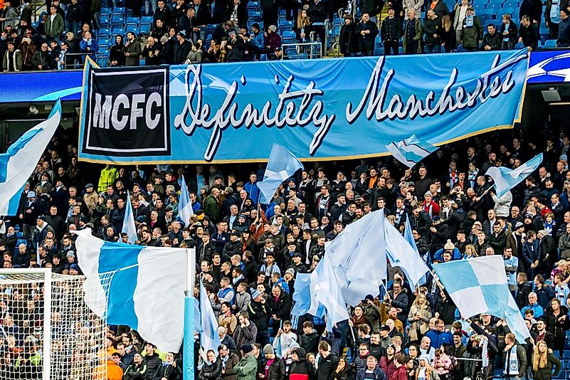 Fans and supporters with mcfc definitely manchester banner During the Champions League match Manchester City - Feyenoord at the Etihad Stadium. Credit: kivnl / Shutterstock.com Fans and supporters with mcfc definitely manchester banner During the Champions League match Manchester City - Feyenoord at the Etihad Stadium