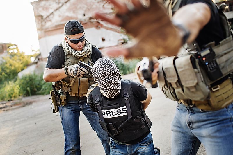 Terrorists holding a gun to a photo journalist head