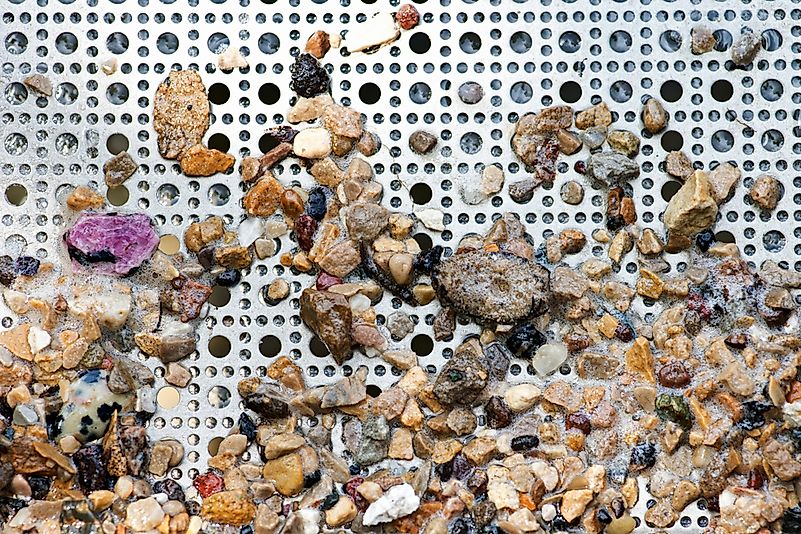 Gemstone panning with a sluice box.