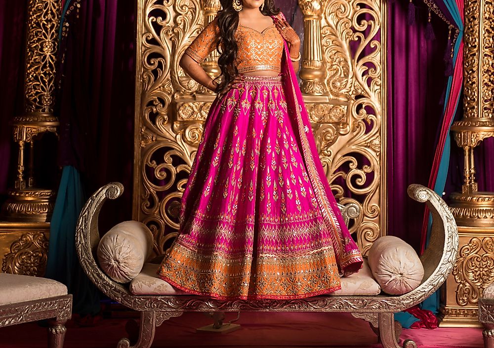 A woman wearing a traditional Indian lehenga choli with heavy embroidery.
