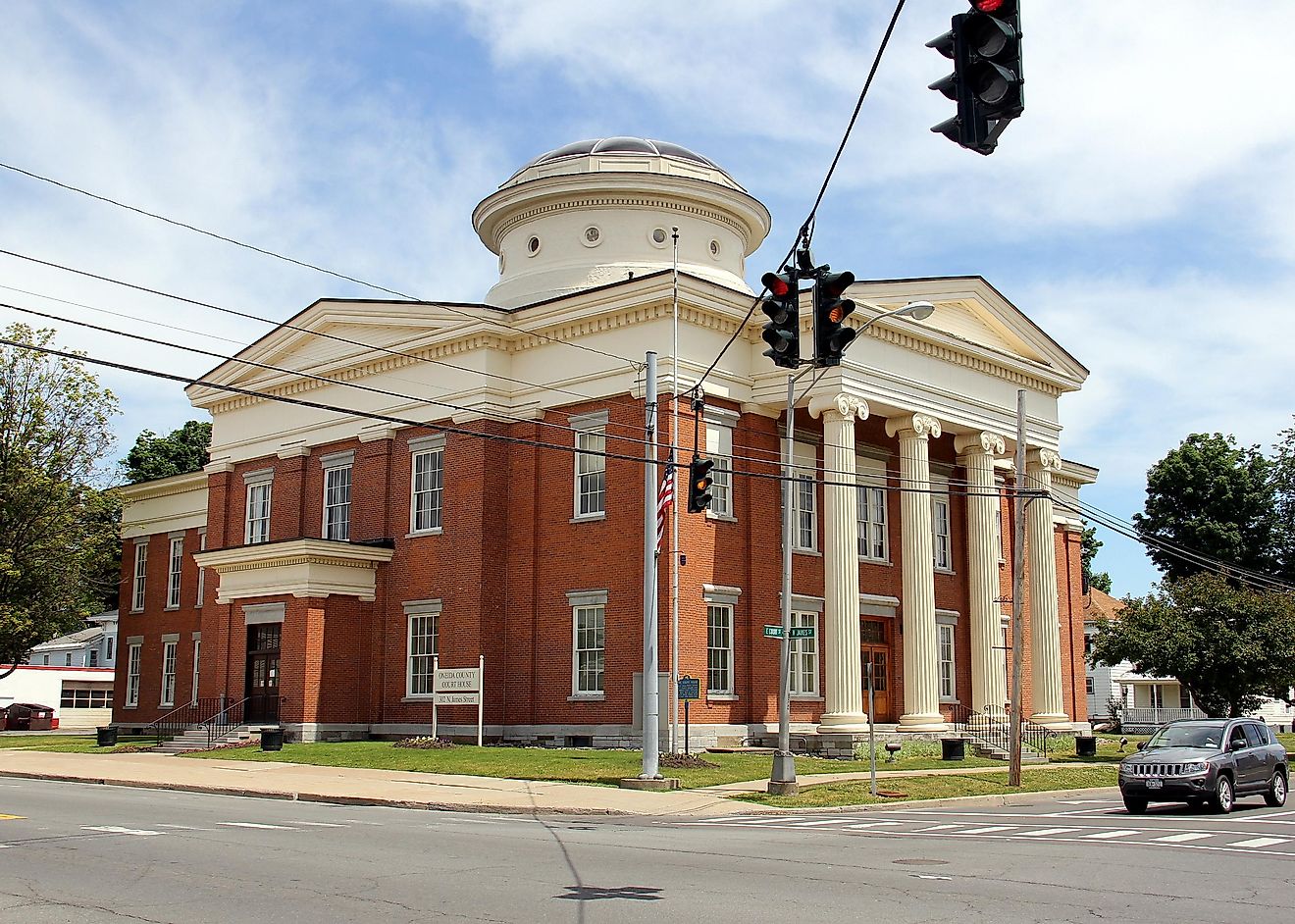 The colorful red bricks and white dome of the Oneida County Courthouse in Rome, New York.