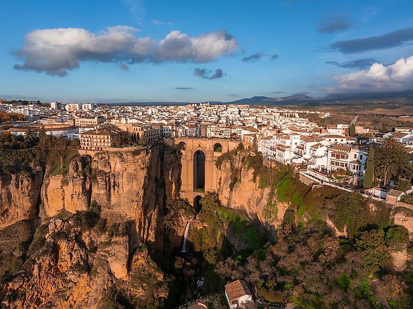 Aerial image of Ronda, Spain, showcasing Puente Nuevo bridge over El Tajo gorge.