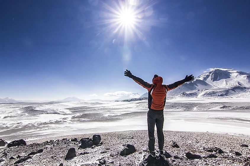 A man standing near Ojos del Salado volcano in Chile.