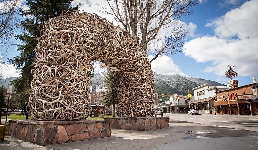 Famous Antler Arch at Jackson Town Square, with Cowboy Bar and ski slopes in the background