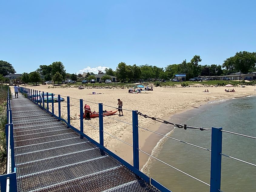 Walking down a pier looking over a casual sandy beach