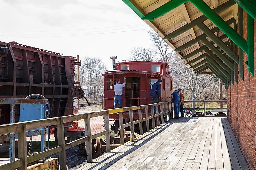 Workers restoring old Long Island Railroad train at The Railroad Museum of Long Island in Greenport