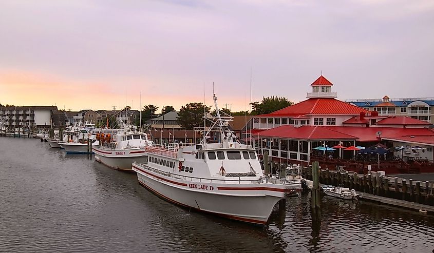 Tour boats and fishing boats are moored in the harbor at sunset in Lewes, Delaware, a United States eastern shore town rich in Civil War history.