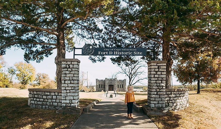 Child standing in front of Fort D Historic Site in Missouri.
