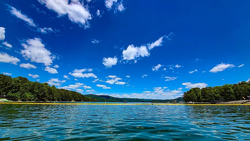 A view of the lake and mountains under the clear blue skies at Devils Fork State Park on Lake Jocassee in South Carolina.