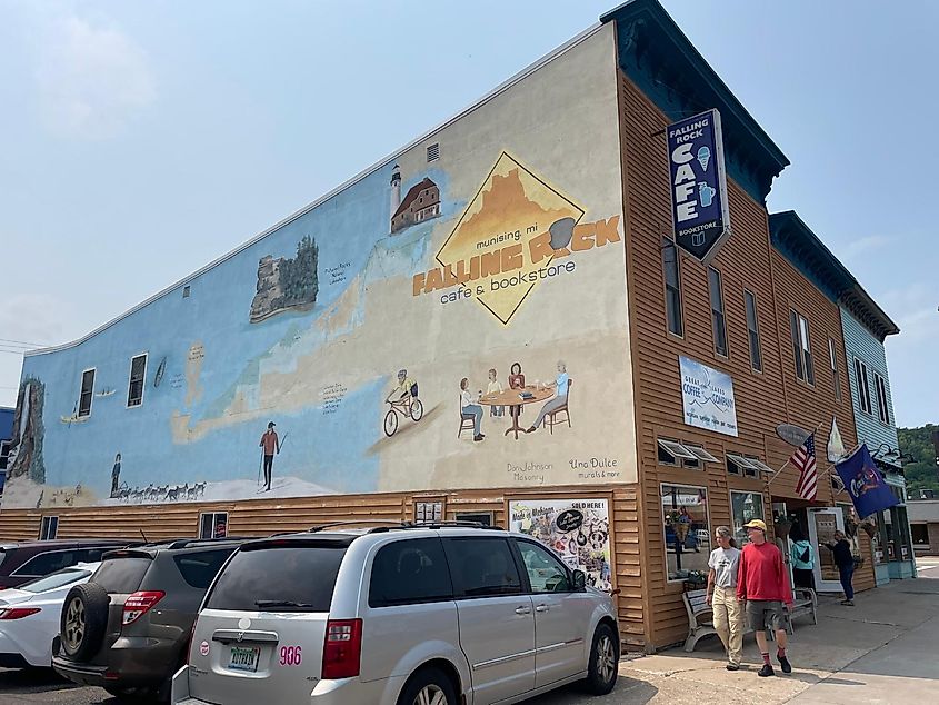 A cafe/bookstore with a large mural across its side wall.