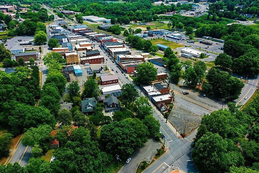 A drone shot of trees and small rural houses in the town of Elkin, North Carolina