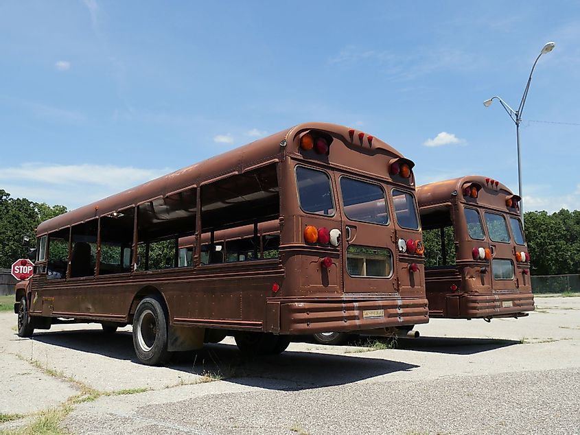 Vintage rustic tour buses without the glass windows at a parking lot in Davis, Oklahoma
