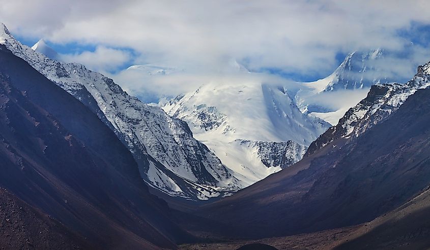 View of the mountains of the Hindu Kush from Tajikistan. Panoramic view of snow-capped peaks. Traveling in Asia, Silk Road.