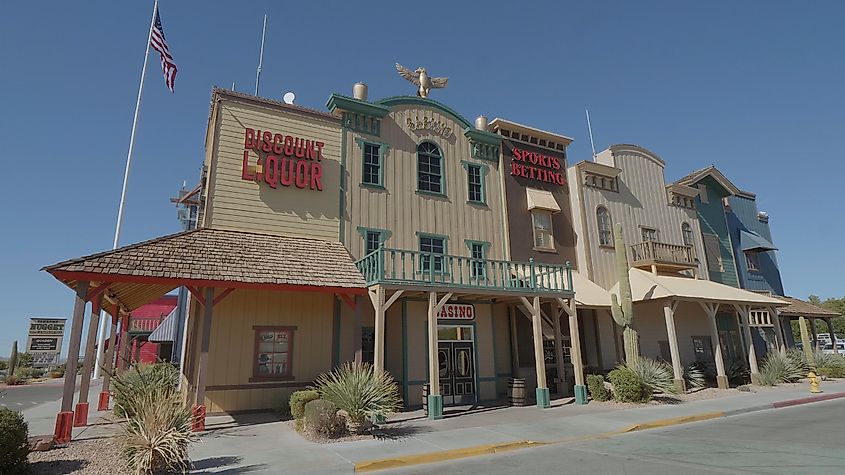 Classic Nevada saloon and casino building in Pahrump, featuring wooden exteriors and vintage signs, set against a bright blue sky