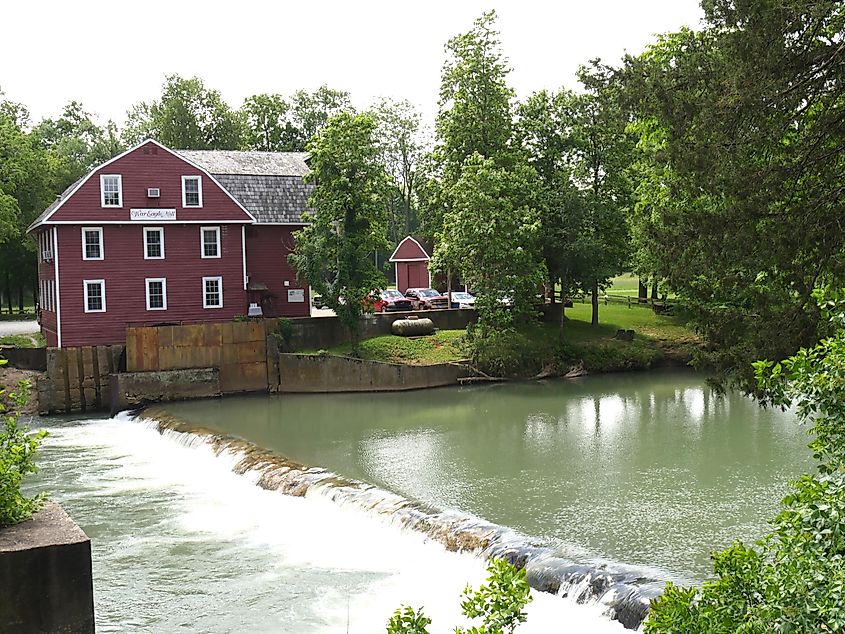 Historic War Eagle Mill building viewed from across the river in Rogers, Arkansas.