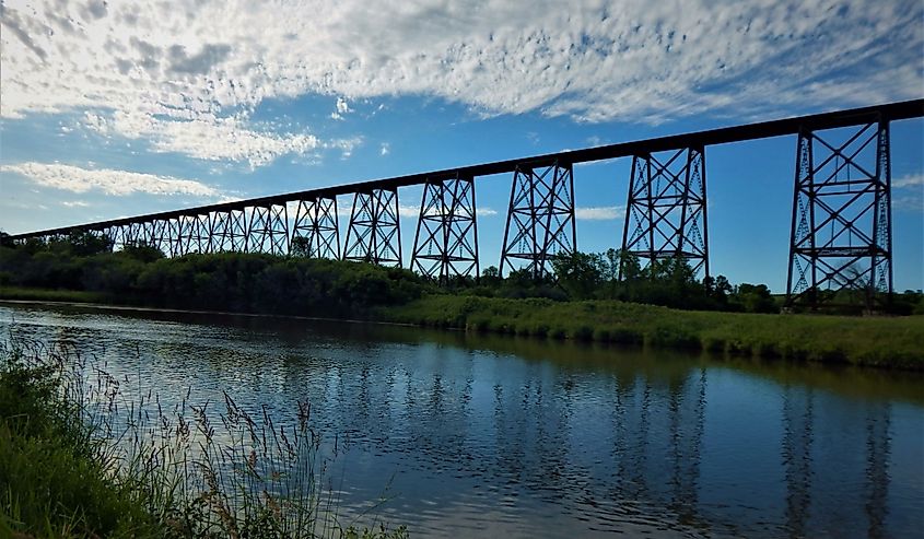 Hi-line bridge over the Sheyenne River reflected in the water.
