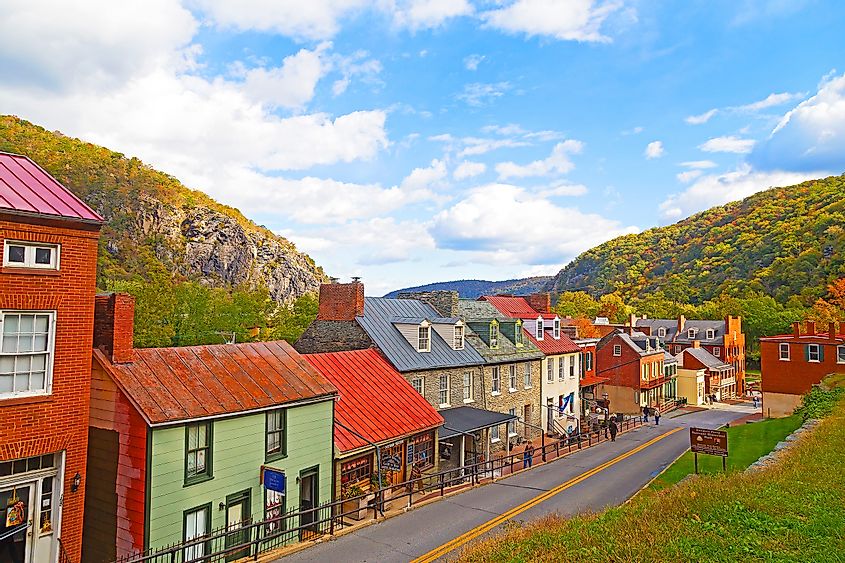 Colorful homes in Harpers Ferry surrounded by fall landscape.