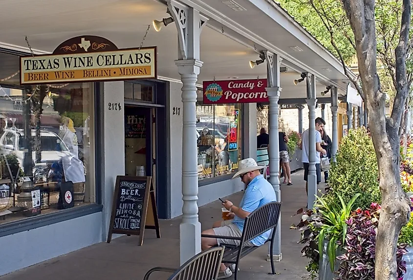 People walking around downtown Fredericksburg, Texas along the main street