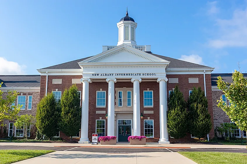 Editorial Photo Credit:grandbrothers via Shutterstock. New Albany, OH, USA 08-06-2022: Close up image of the Intermediate School building featuring tall pillars, brick exterior, white octagonal cupola. Concept image for classical school architecture