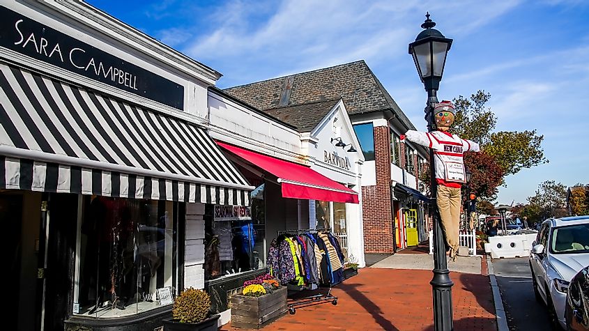 Walkway with store fronts and autumn decoration in New Canaan, Connecticut.