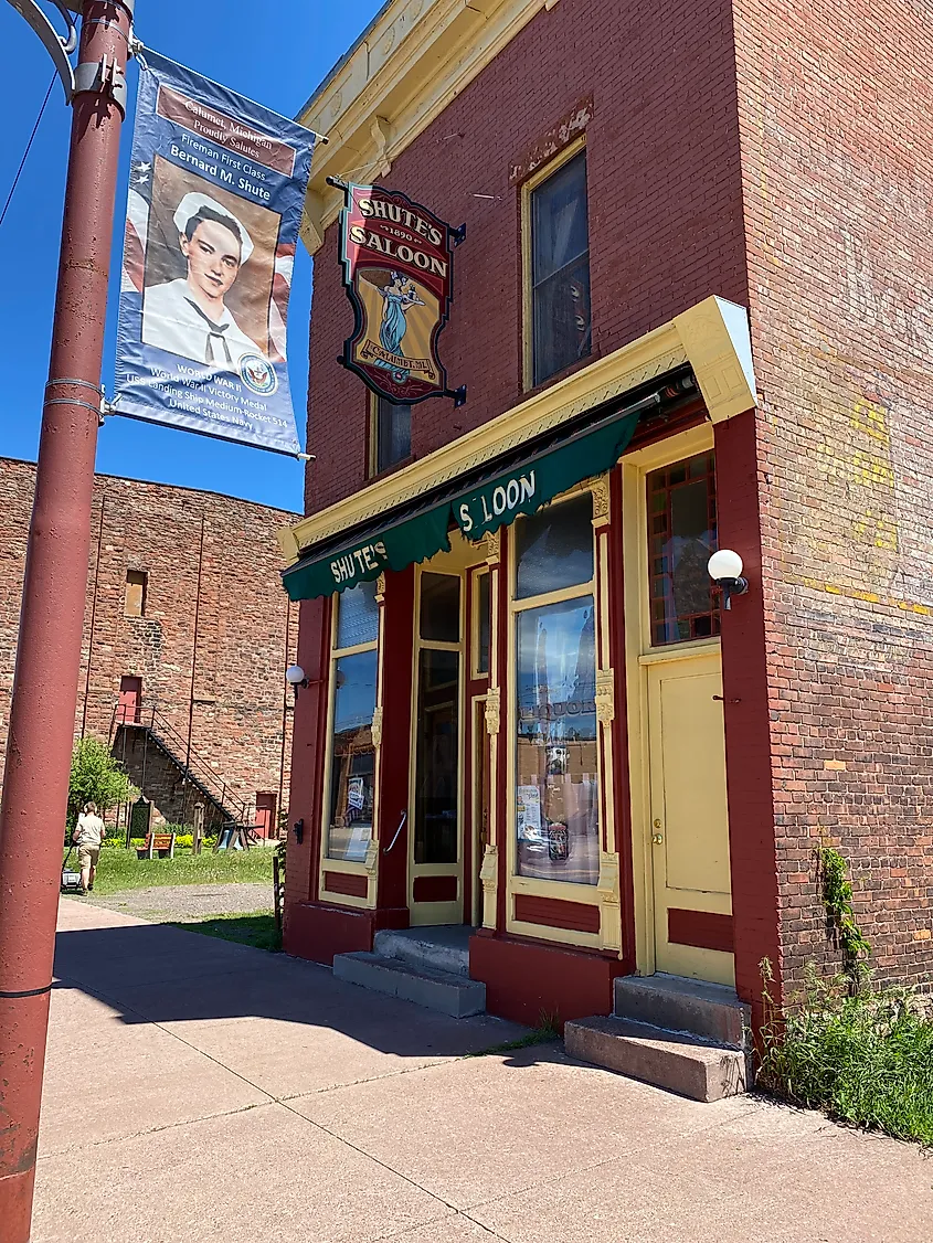 The weathered, red-brick exterior of an old saloon. 
