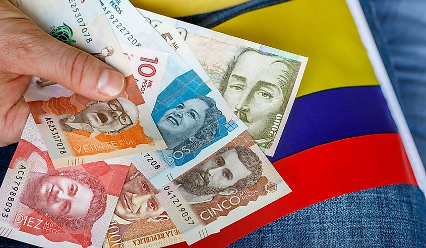 Colombian pesos with the national flag in the background