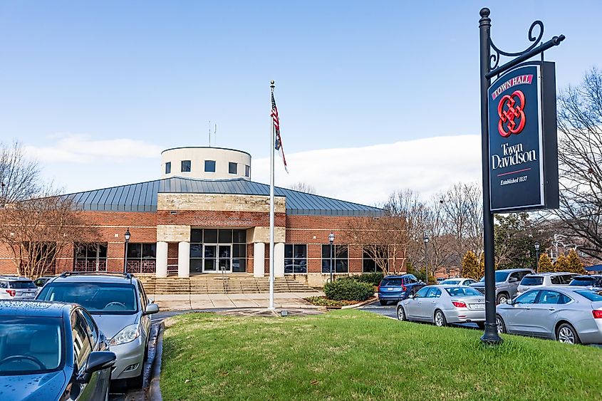 Davidson Town Hall with the American flag in Davidson, North Carolina.