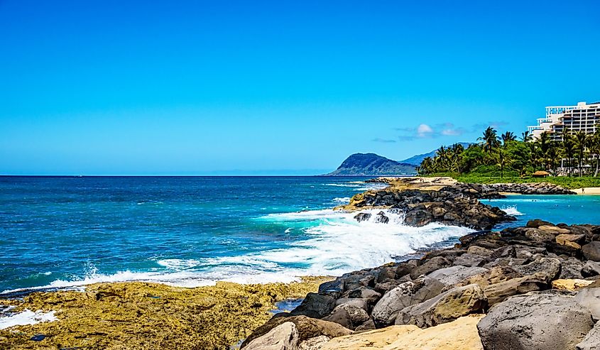 Waves of the Pacific Ocean crashing on the rocks on the shoreline of Ko Olina on the island of Oahu in the island state of Hawaii