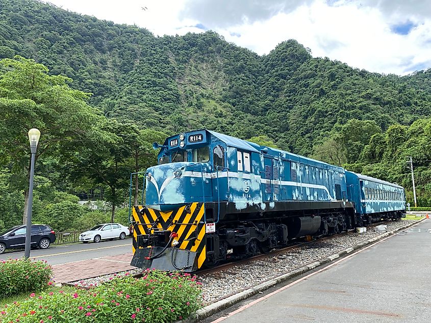 A decorated train car (now an interactive museum) sits amongst the forested mountainscape of Checheng, Taiwan.