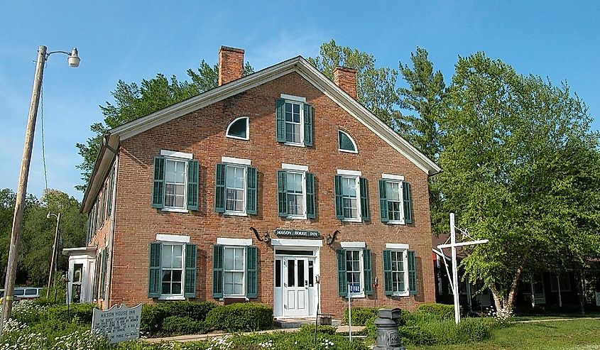 Home in the Bentonsport National Historic District with green trees surrounding.