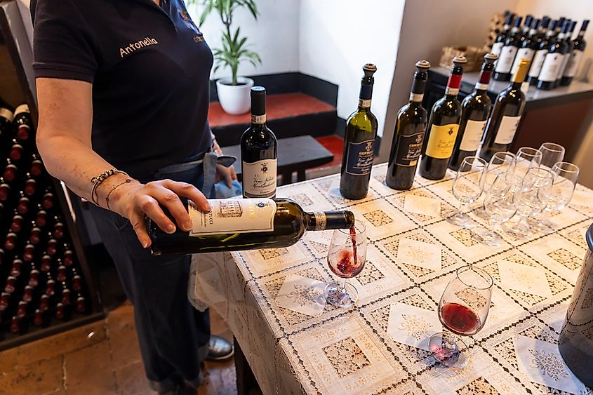 A worker pours wine for tasting at the Contucci winery in Montepulciano, Italy.