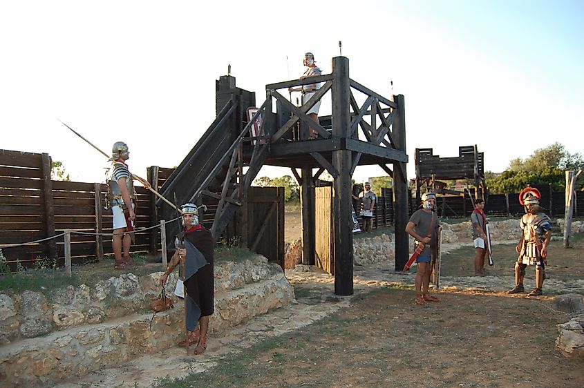 Reenactors inside of a Roman fort in Sardinia. Castrum La Crucca, CC BY-SA 4.0, via Wikimedia Commons.
