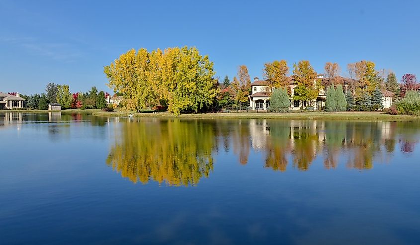 Red and yellow colored trees near lake on sunny day in October Cherry Hills Village, Denver, Colorado