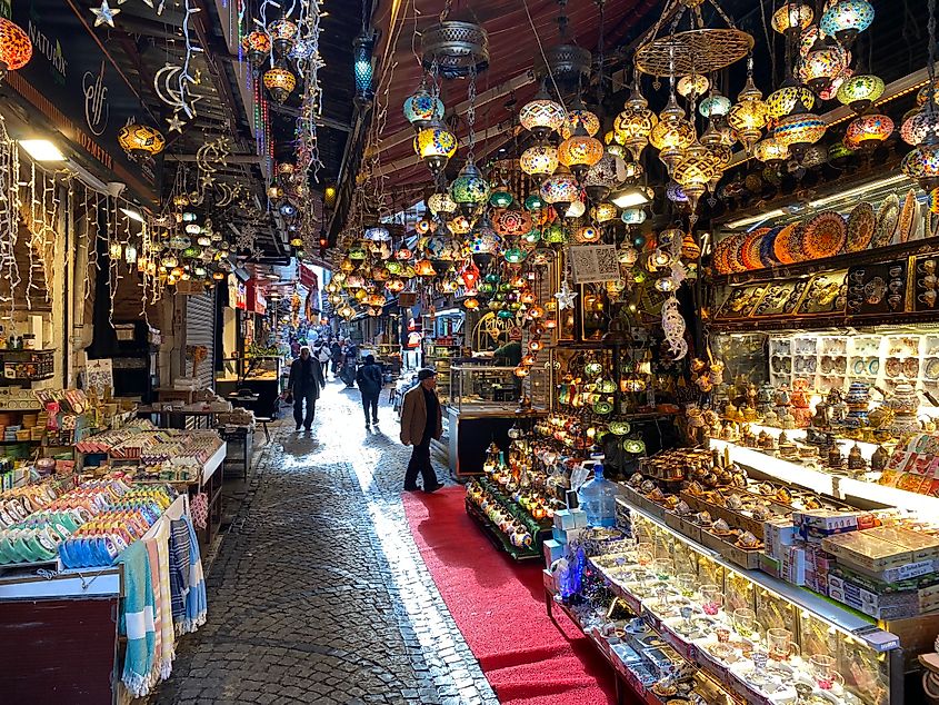 A narrow alley leads through the traditional lamp section of an Istanbul market.