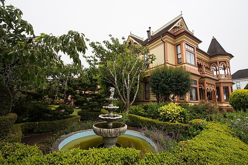 Garden fountain and greenery at the Gingerbread Mansion Bed and Breakfast in Northern California's Fortuna, via melissamn / Shutterstock.com