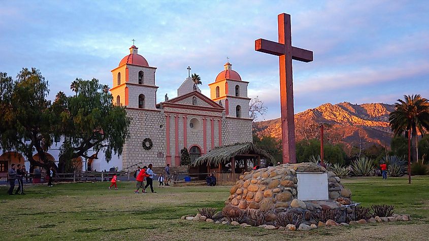 The last sun of the day hits the bell towers at Old Mission Santa Barbara in Santa Barbara California