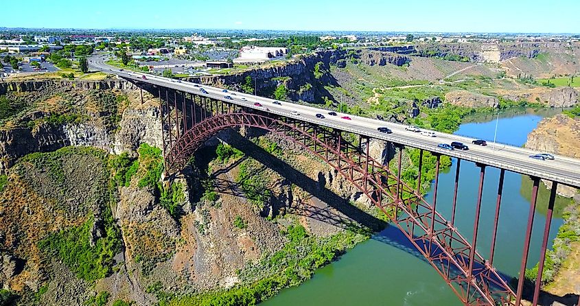 Distant aerial view over the river canyon with cars driving on the road at Perrine Bridge, Twin Falls, Idaho, USA.
