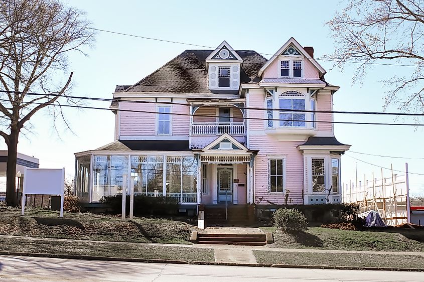 Pink historic mansion in LaGrange, Georgia, lit by the morning sun on a clear day
